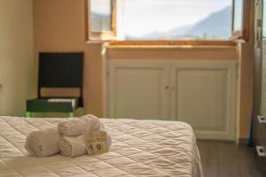 a bedroom with a bed with a teddy bear on it at La Caletta 4 in La Caletta