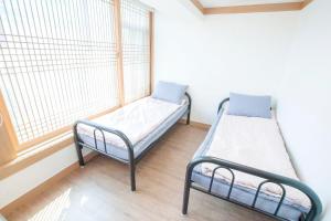 Postel nebo postele na pokoji v ubytování Cocoa Guesthouse