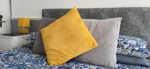 a yellow pillow sitting on a bed with pillows at The Aldor in Skegness
