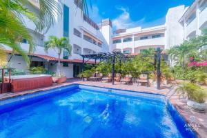 a swimming pool in front of a building at Ideal Group Getaway 4 blocks to the Beach & Pool in Playa del Carmen