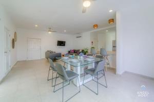 a dining room and living room with a table and chairs at Ideal Group Getaway 4 blocks to the Beach & Pool in Playa del Carmen