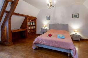 a bedroom with a bed with two pillows on it at Gite du Lavoir in Cherveix-Cubas