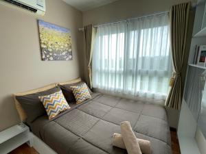 a bedroom with a large bed with a window at The Trust Condo Huahin Soi5 in Hua Hin +30 photos