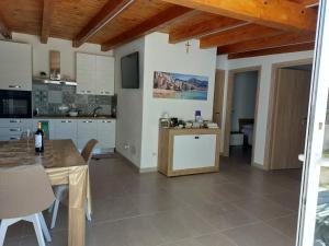 a kitchen and dining room with a table and chairs at Casa Asprigna in Ficarazzi
