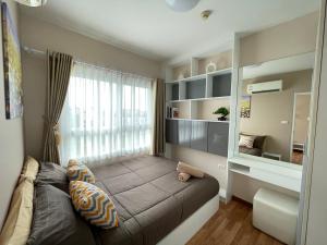 a bedroom with a large bed and a window at The Trust Condo Huahin Soi5 in Hua Hin