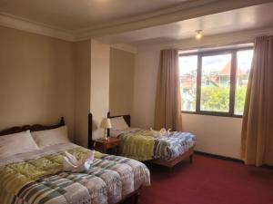 En eller flere senge i et værelse på HOTEL HUAYNAPATA Pardo + 35 billeder