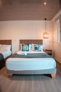 Postel nebo postele na pokoji v ubytování Mangrove Bay Hotel San Andrés Islas
