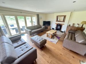 a living room with two couches and a television at Meadow Shores - Part of the The Bay Filey Holiday Village with pool, gym and direct beach access, pub, restaurant, tennis and meadows walks in Filey