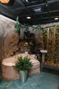 a bath tub in a room with plants at 5th East Hall Bed & Breakfast in American Fork +29 photos