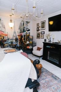 a living room with a fireplace and a tv at 5th East Hall Bed & Breakfast in American Fork