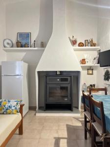 a living room with a fireplace with a white hood at Can Mateu 1924 in Sant Francesc Xavier