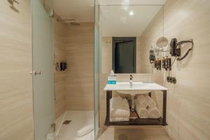 a bathroom with a sink and a shower at ABC Hotel Porto - Campanhã in Porto +43 photos