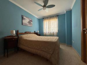 a bedroom with a bed and a ceiling fan at Voramar VI in Piles +9 photos