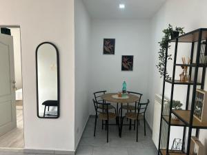 a dining room with a table and chairs and a mirror at Alex House in Făgăraş