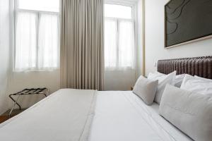 Ένα ή περισσότερα κρεβάτια σε δωμάτιο στο GuestReady - Vanzeleres Collection
