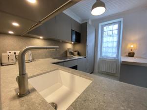 a kitchen with a sink and a window at La Maison Havre de Paix in Saint-Clément-des-Baleines