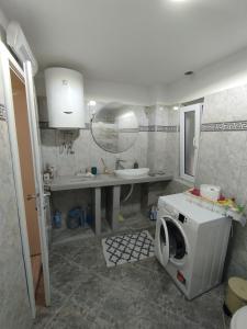 a bathroom with a sink and a washing machine at Amarillys in Donji Morinj +14 photos
