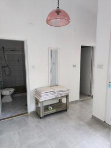 a bathroom with a bench in the middle of a room at Apartments Kočović in Peroj
