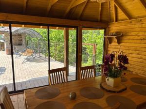 a dining room with a table and a view of a playground at Apartamentai Renata in Druskininkai