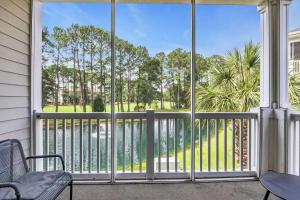 a screened in porch with a view of a pool at Angie's Place w Golf Views Plus Huge Resort Pool in North Myrtle Beach