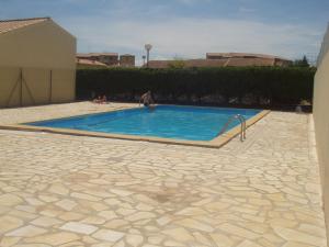 a man is sitting in a swimming pool at studio saint-pierre la mer in Fleury
