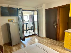 a kitchen with a refrigerator and a dining room at Studio Neven with Sea View in Baška