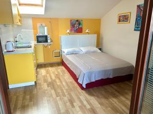 a small bedroom with a bed and a kitchen at Studio Neven with Sea View in Baška