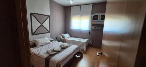 a small room with two beds and a window at Chalet vacacional en Pelayos in Pelayos de la Presa +24 photos