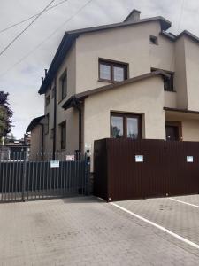 a house with a fence in front of it at Mieszkanie na Wygodzie M2-parking free in Białystok