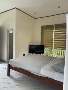 a bedroom with a large bed and a window at Octagon in Caylaway