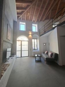 a living room with a couch and a table at Beautiful Plomari Cottage in Plomarion +11 photos