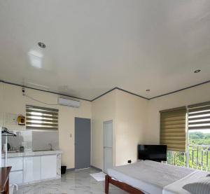 a large bedroom with a bed and a kitchen at Octagon in Caylaway