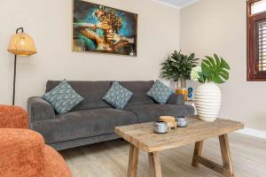 a living room with a couch and a coffee table at Elegancia Ocean View with Cooling Pool in Kralendijk +51 photos