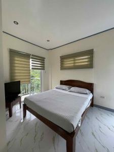 a bedroom with a bed and a flat screen tv at Octagon in Caylaway