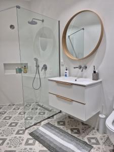 a bathroom with a sink and a mirror at Beautiful Plomari Cottage in Plomari +11 photos