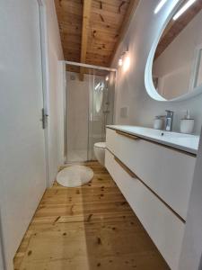 a bathroom with a sink and a toilet and a mirror at Beautiful Plomari Cottage in Plomarion
