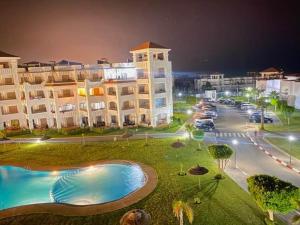 a view of a large building at night at Beralmar Asilah New in Asilah