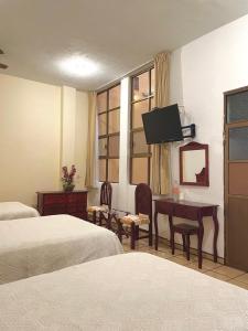 Un pat sau paturi într-o cameră la Hotel Casa Cortes