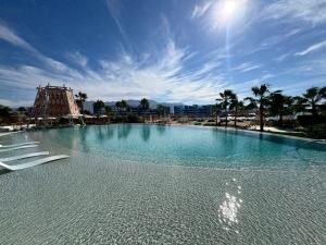 a large swimming pool with a roller coaster in the background at Ayla Aqaba Azure 2 bedroom in Aqaba