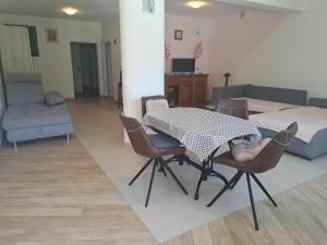 a living room with a table and chairs and a bed at Apartma Solina in Portorož