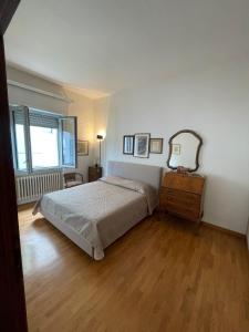 a bedroom with a bed and a dresser and a window at La casa nel Borgo in Borgo San Lorenzo