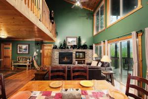 a living room with a table and a fireplace at Pool table, pet friendly, hot tub, & mountain view, 3 bedrooms in Sevierville