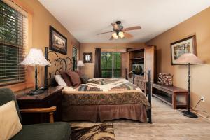 a bedroom with a bed and a ceiling fan at Pool table, pet friendly, hot tub, & mountain view, 3 bedrooms in Sevierville