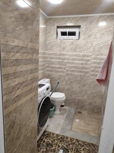 a bathroom with a toilet and a window at Comfort House in Aghk'ilisa +1 photo