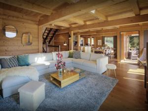 a living room with a white couch and a table at Chalet Parakima - OVO Network in Manigod