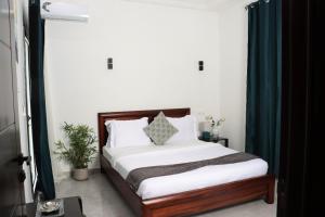 a bedroom with a bed with a green curtain at Casa Luna - Villa Mango in Pointe-Noire