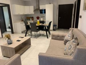a living room with a couch and a table at RoyalRest at Signature CPG in Accra