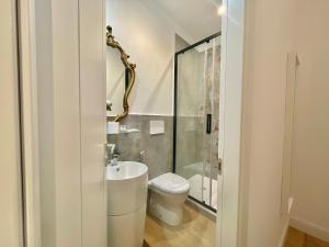 a white bathroom with a toilet and a shower at Happy Family Apartments Soziglia in Genova