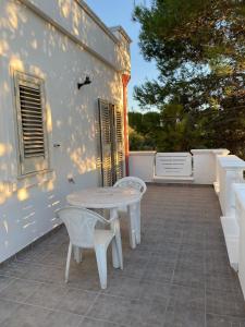 a table and two chairs on a patio at Tenuta Sillo Primo Piano in Uggiano Montefusco +9 photos