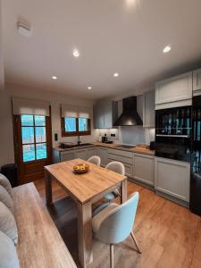 a kitchen with a wooden table and chairs at Casa Lignum in Metsovo +22 photos
